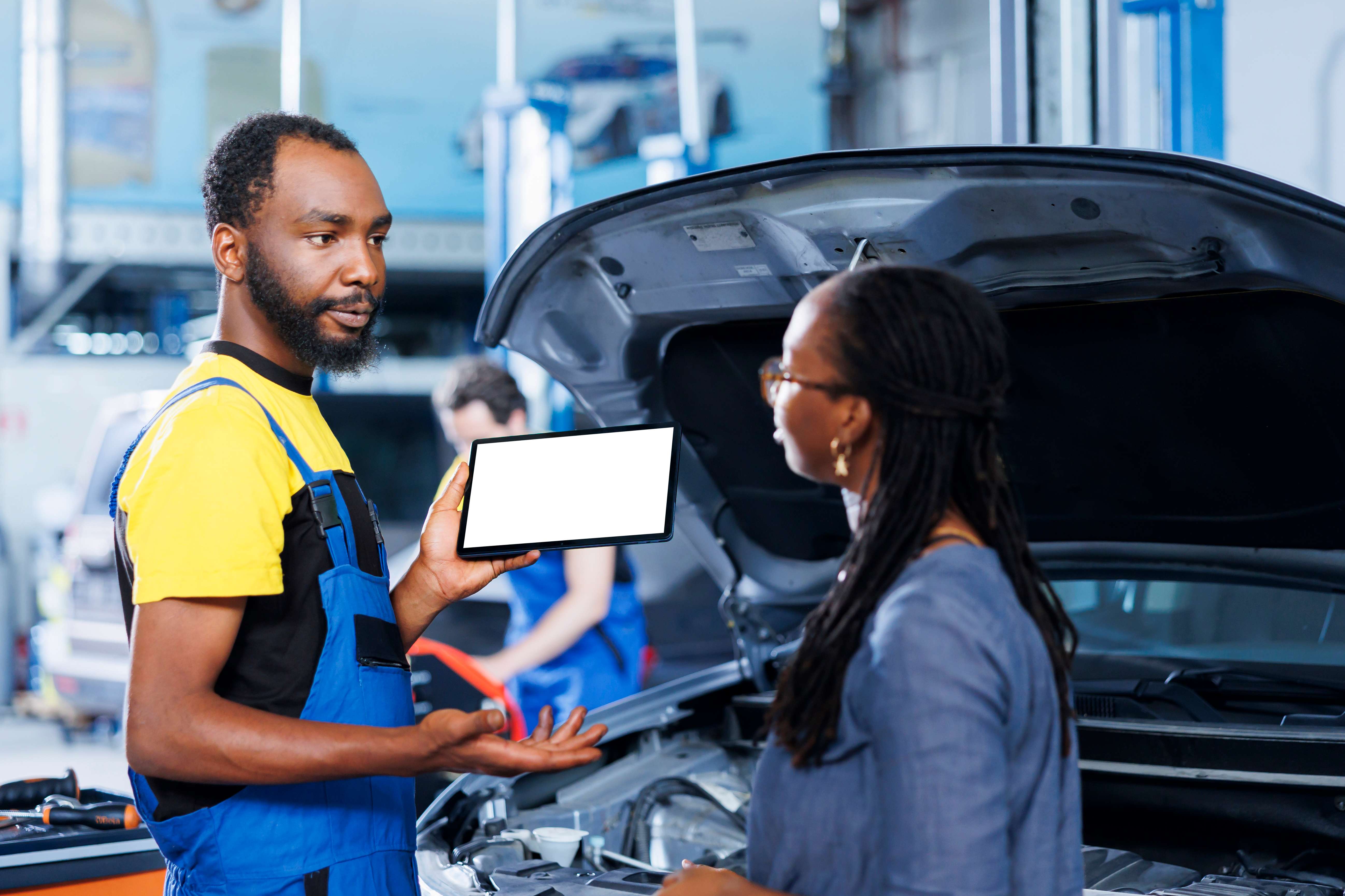 Mechanic explaining diagnostics to customer